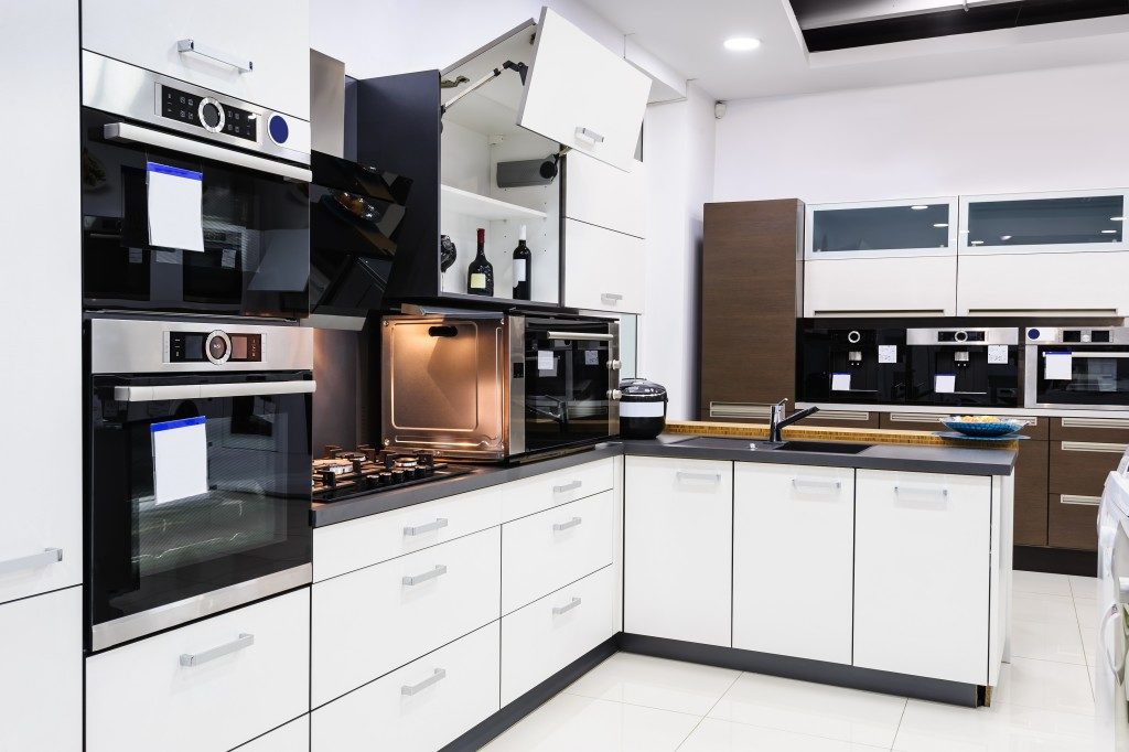 white kitchen with black appliances