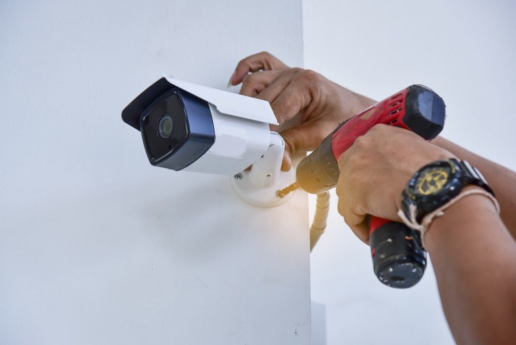 person installing security camera