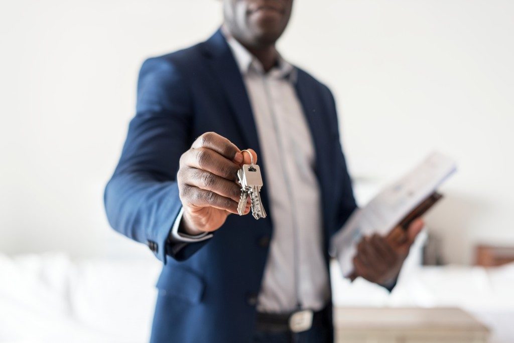 real estate agent handing the keys to property