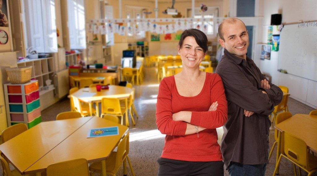 Two teachers posing in the classroom