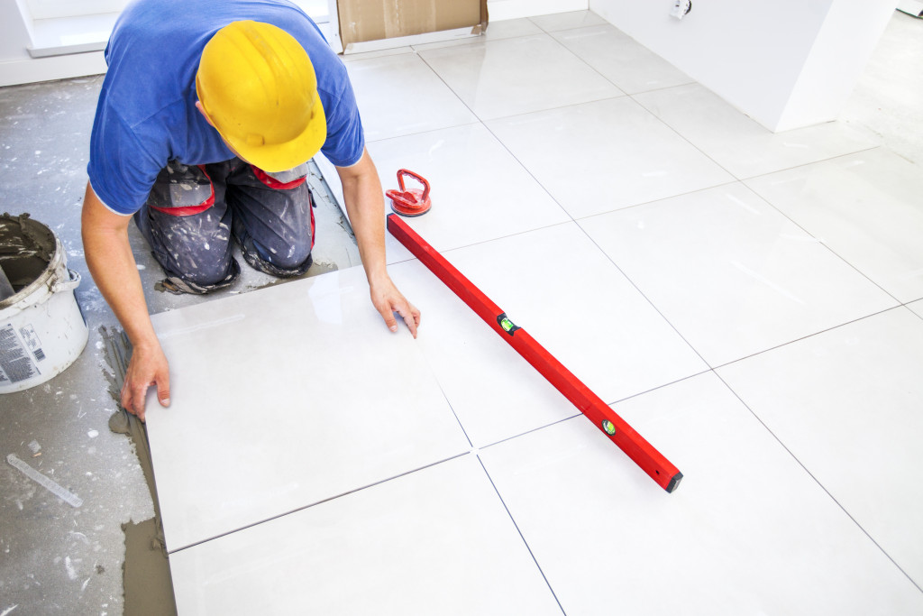 worker laying tiles