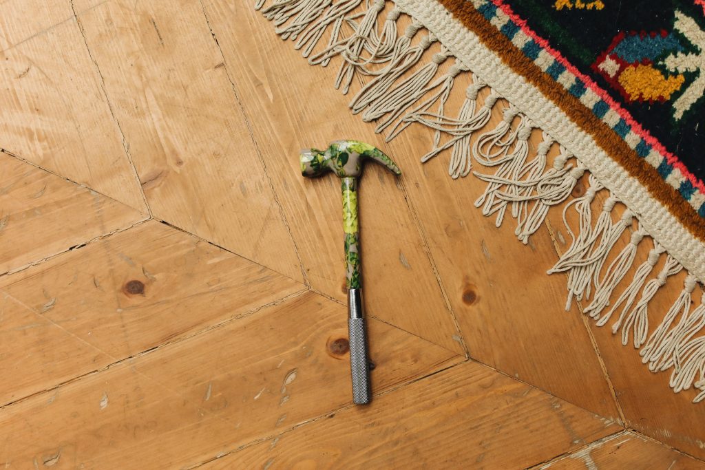 hammer and rug on hardwood flooring